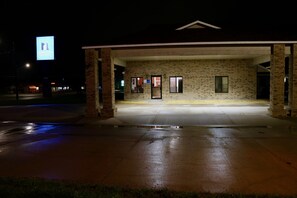 A building with a brick facade and a covered entrance area.