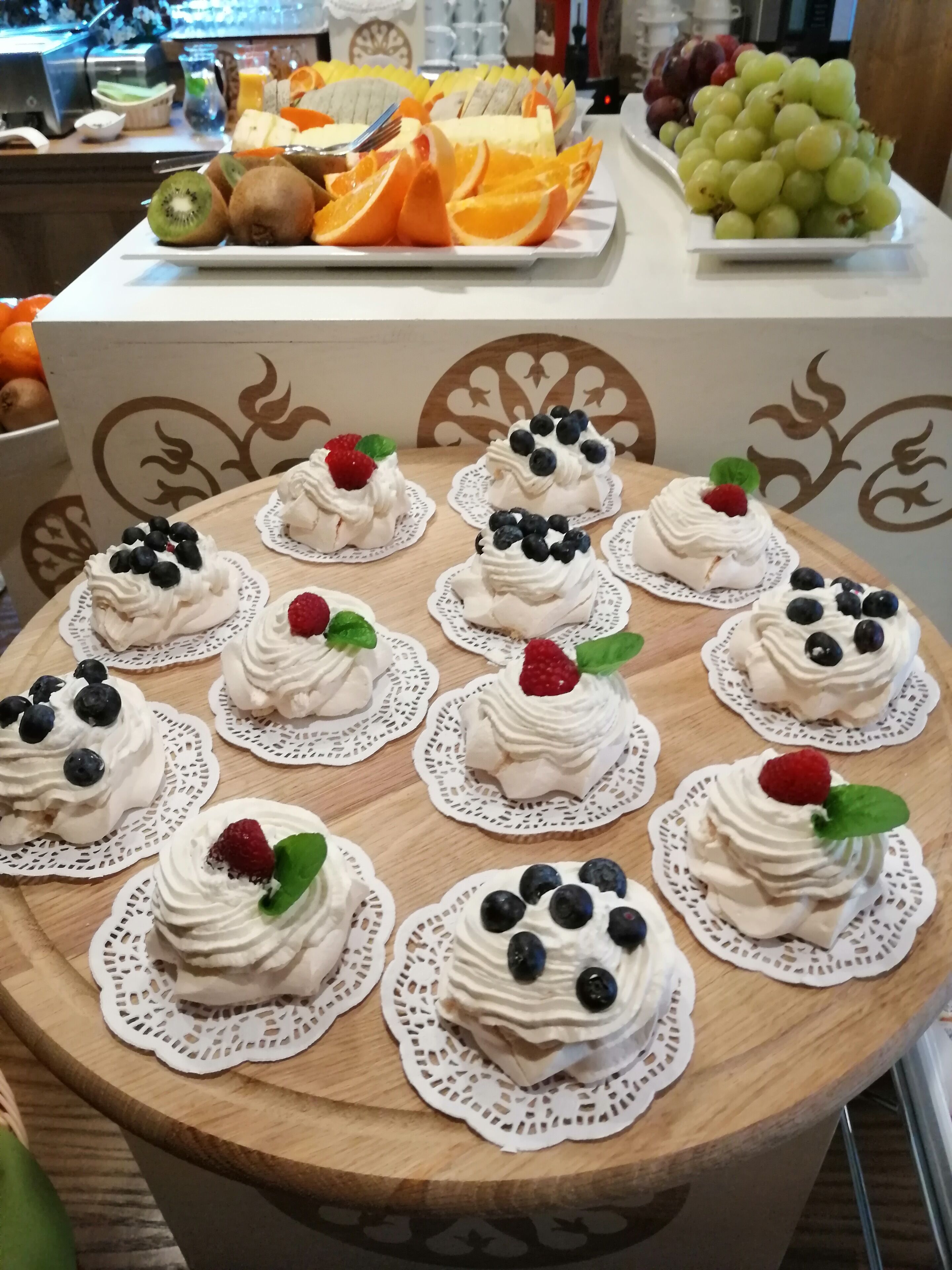 A table with fruit and dessert items.