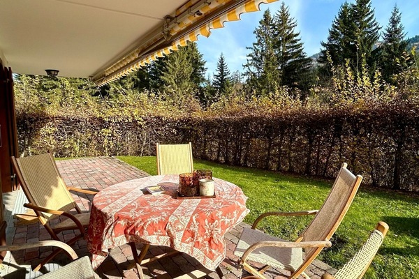 Imagine a stunning patio adorned with lush green grass and a cozy sitting area, ideal for enjoying a delightful breakfast in the fresh morning air.