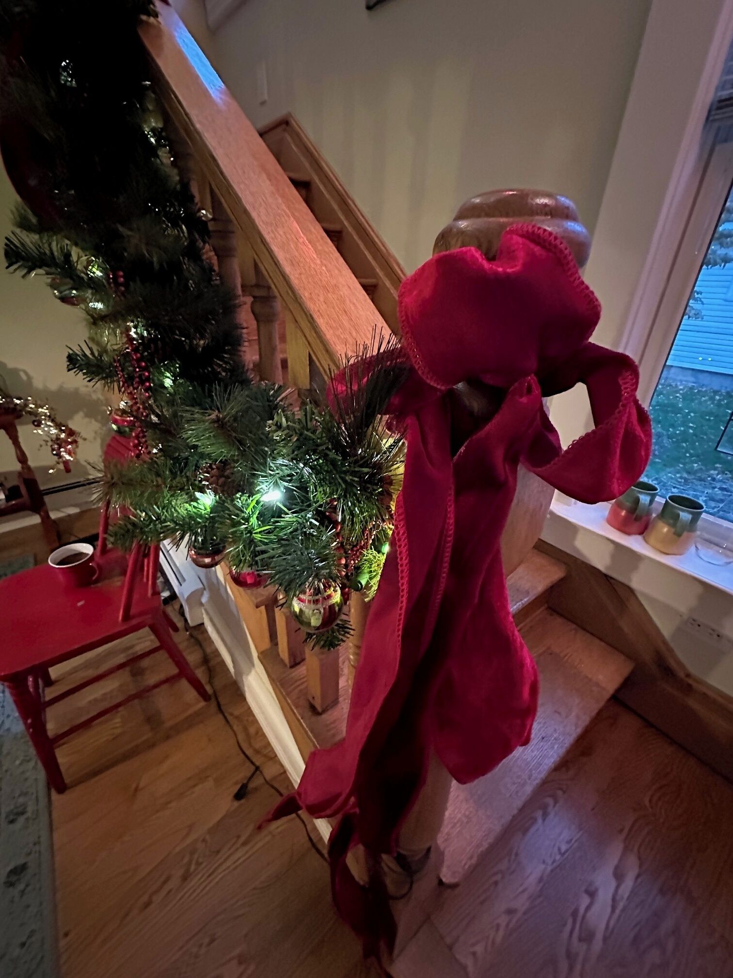 A staircase with a Christmas tree decorated with lights and ornaments.