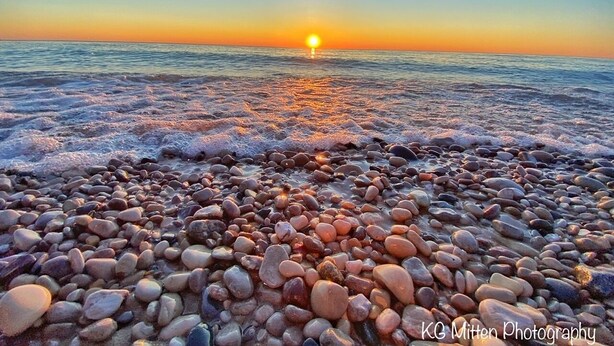 A pebbled beach at sunset with a clear sky. - Historical home, the Burnett Nestt in the heart of Lake Ann  (Lake Ann)