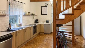 A kitchen with wooden cabinets, a microwave, and a sink. - 4 bedroom lovely home in Zalewo (Zalewo)