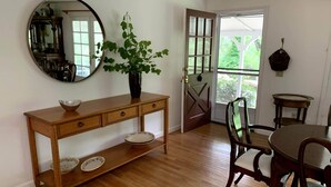 A dining area with a wooden console table, a mirror, and a potted plant. - Hidden Country Gem with Pond | Free Early In & Late Out | Pet Friendly! (Nevada City)