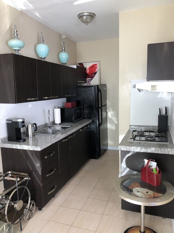 Fridge, microwave, stovetop, coffee/tea maker