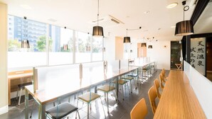 A modern conference room with glass partitions, wooden tables, and chairs. - Super Hotel Natural Hot Springs Fuji (Fuji)