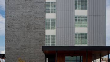 A modern building with a brick facade and large windows.