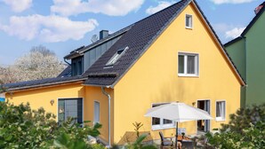 A yellow house with a sloped roof, a satellite dish, and a small window. - Vacation in Saxon Switzerland (Pirna OT. Graupa)
