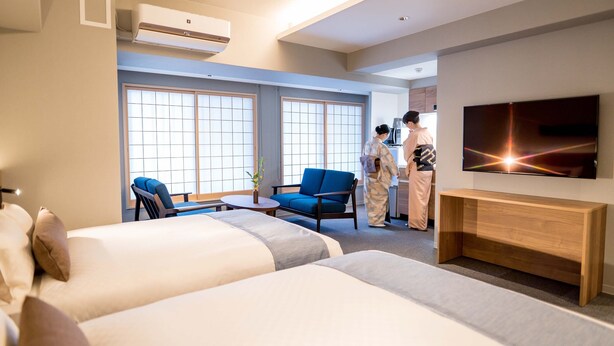 A hotel room with two beds, a TV, a desk, and a bathroom. - RESI STAY HOTEL SUN CHLORELLA　 (Kyoto)