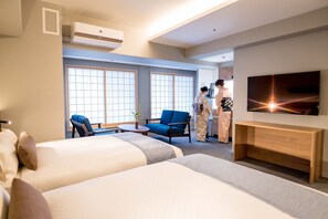 A hotel room with two beds, a TV, a desk, and a bathroom. - RESI STAY HOTEL SUN CHLORELLA　 (Kyoto)