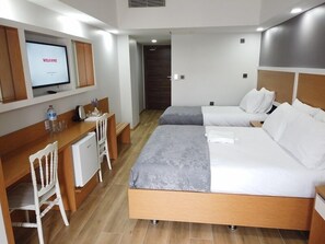 A hotel room with two beds, a desk, a chair, a television, and a wardrobe. - Asiwa Otel (Eskisehir)