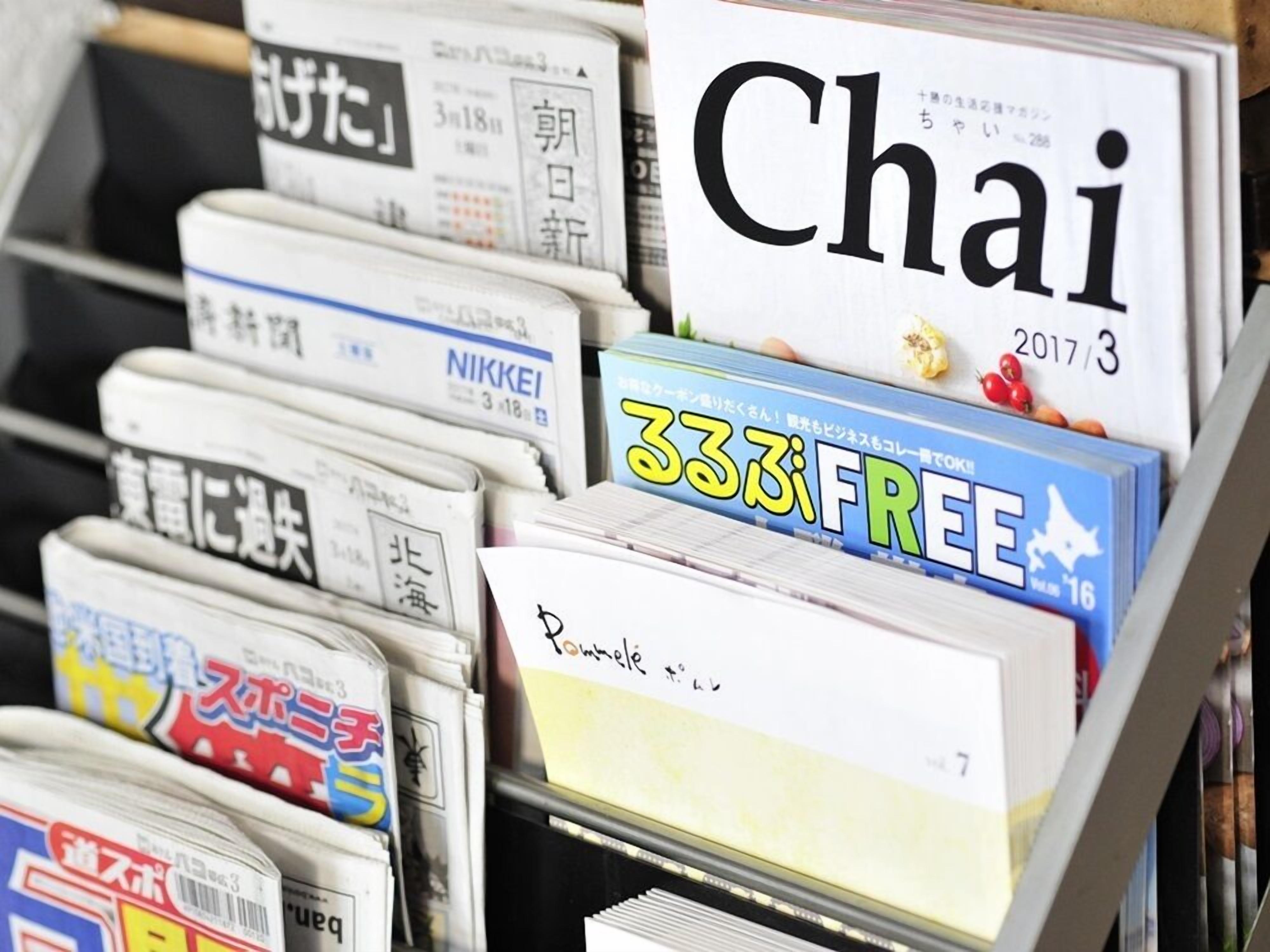 A stack of newspapers with a prominent 'Chai' magazine on top.