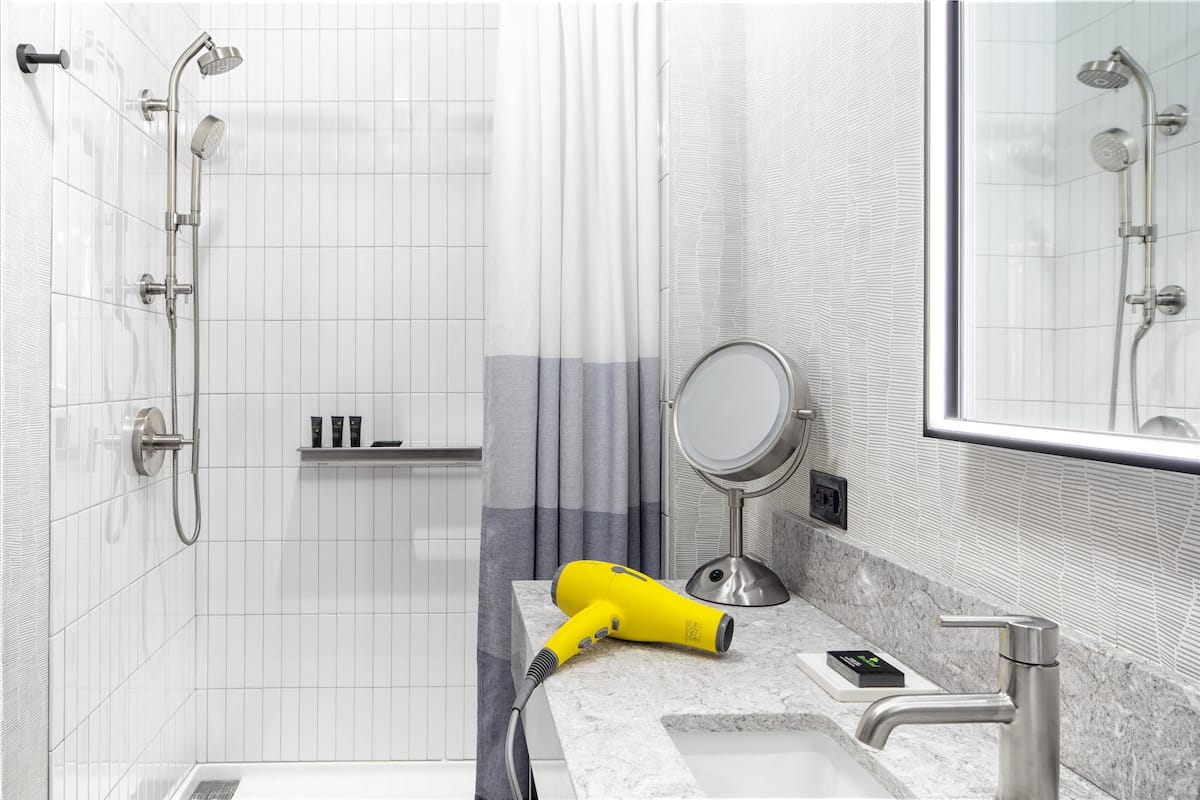 room, 1 king bed, corner | bathroom | designer toiletries, hair dryer, bathrobes, slippers