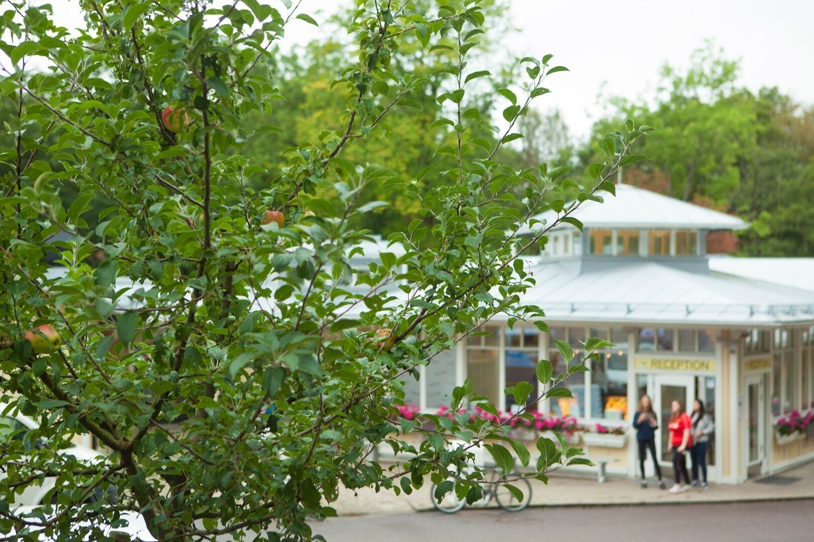 A building with a reception area and people standing outside.