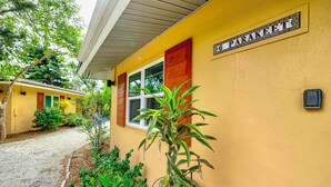 A yellow building with a sign reading "16 PARAKEETS". - Newly remodeled Parakeet cottage!  Walking distance to beach, restaurants, shops! (Sanibel)