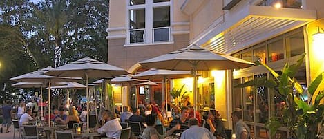 Enjoy al fresco dining under shaded tables with comfortable seating.
