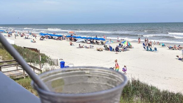 A beach view with a plastic cup in the foreground. - CLEAN , Pet Friendly Beach House w/ golf cart and free beach parking (Surfside Beach)
