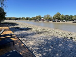 Relax on the riverside deck with benches, surrounded by trees and scenic views.