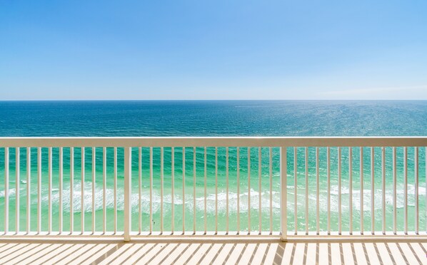 A balcony with a view of the ocean.