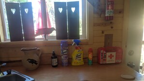 A wooden kitchen counter with a sink, a bird-themed pitcher, and various cleaning supplies. -  11 miles to Kings Canyon Nat'l Park (Miramonte)
