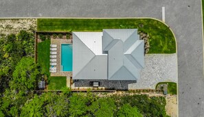 Enjoy a serene atmosphere surrounded by lush greenery and a spacious pool.