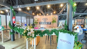 A reception area with a sign reading "RECEPTION" and a counter with a sign for "CHUKIT CAFE & RESTAURANT".