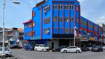 Hotel Kangar offers a welcoming presence with its vibrant facade and red accents.
