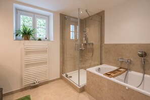 Bathtub, hair dryer, slippers, towels