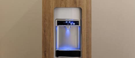 A water dispenser integrated into a wooden panel.