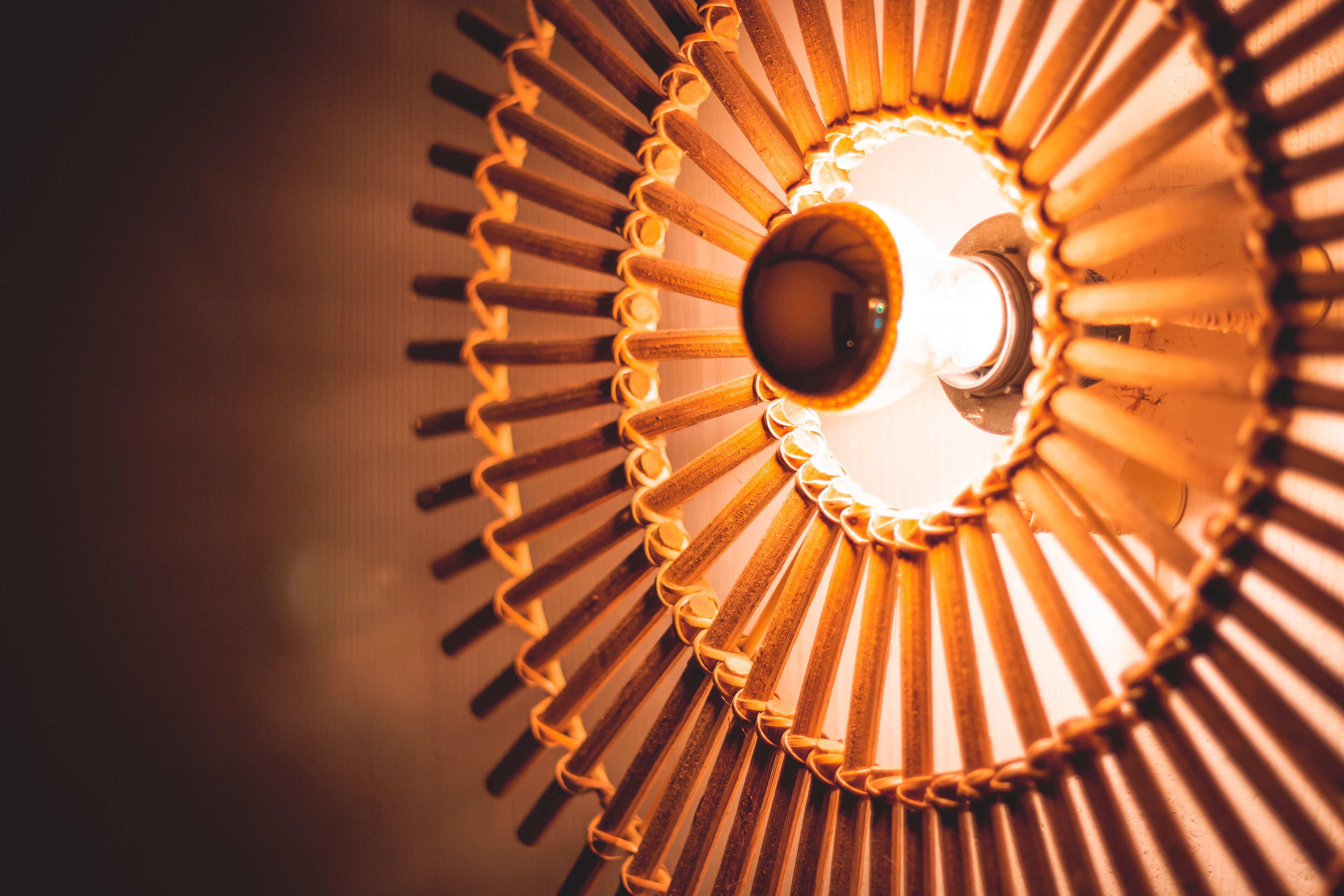 A close-up of a spiral staircase with a central light fixture.