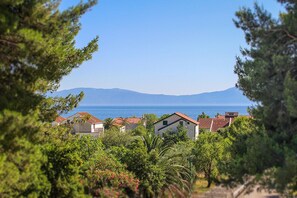 A coastal view with houses and a clear sky.