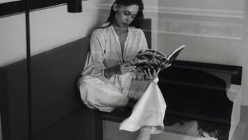 A person sitting on a bench reading a book.