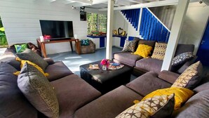 A modern living room with a sectional sofa, a coffee table, and a TV.