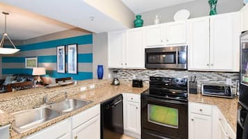 Deluxe Condo, 2 Bedrooms | Private kitchen | Full-size fridge, microwave, oven, stovetop
