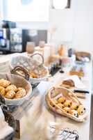 Una vitrina de panadería con diversas opciones de repostería en cestas.