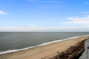 A beach with a clear sky and calm sea. - XPLORIE ACTIVITIES & LINENS INCLUDED*! Direct Oceanfront updated 2BR/2BA condo with an open den. Balcony access from living room and master bedroom. (Ocean City)