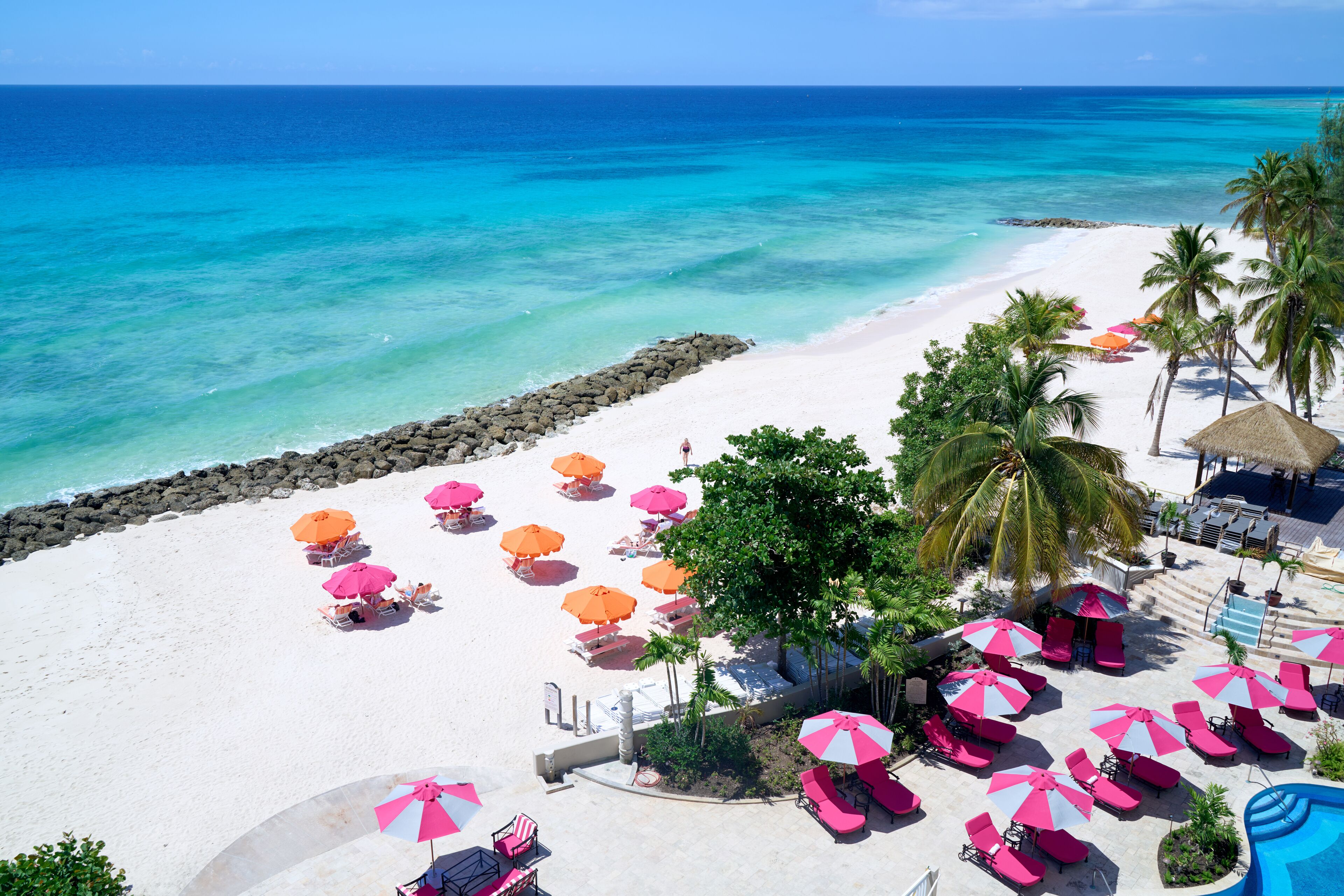 On the beach, white sand, sun loungers, beach umbrellas
