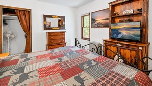 A bedroom with a bed, dresser, mirror, and television. - Bear Slope View - Close to Slopes, Pet Friendly, Fenced Yard, Hot Tub (Big Bear Lake)