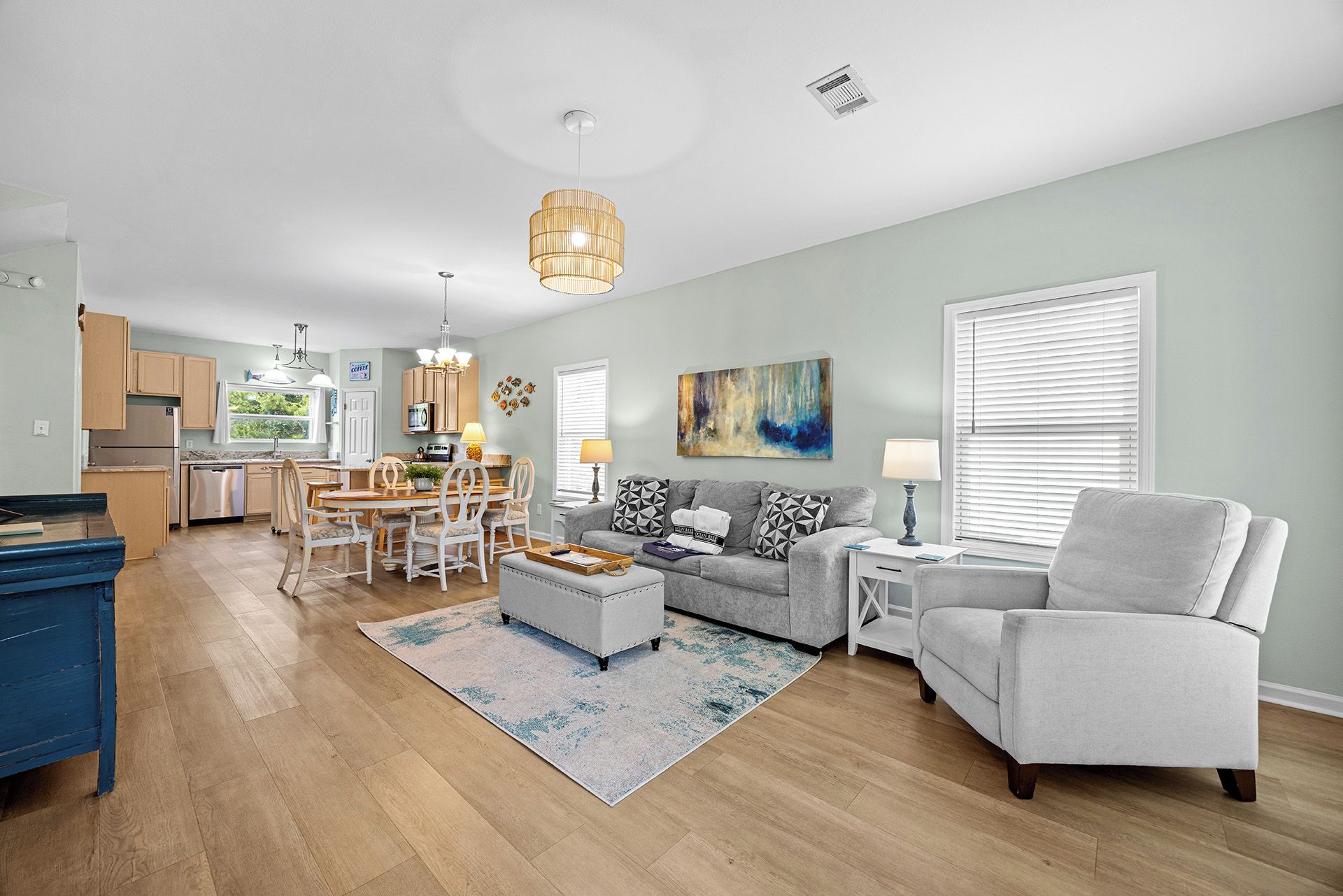 A modern living space with a dining area, kitchen, and seating area.