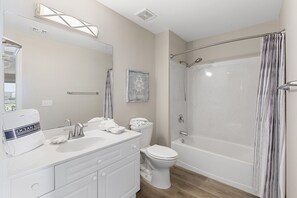 A modern bathroom with a vanity, toilet, and a walk-in shower. - Amalfi Coast 324D - Gulf View, Community Pool, Tennis, Beach Service Included! (Miramar Beach)