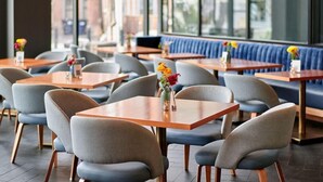 A restaurant interior with tables, chairs, and a blue booth seating area. - Lockwood Hotel (Waterville)