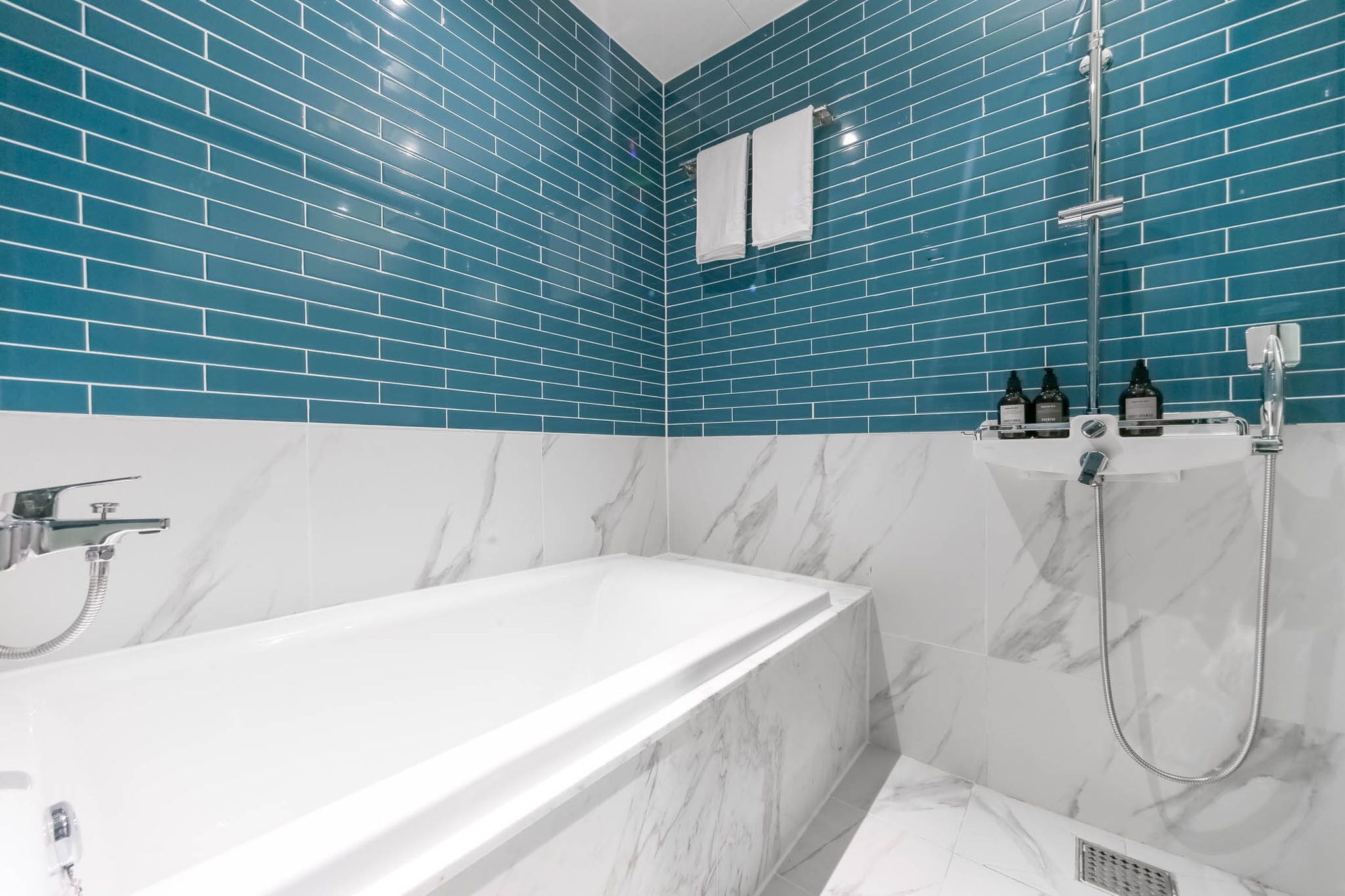 deluxe room | bathroom | shower, free toiletries, hair dryer, slippers