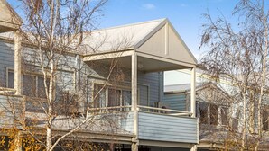 A two-story house with a covered porch and a garage. - Razorback 15 - Central Jindabyne CBD Unit (Jindabyne)