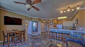 A spacious kitchen with a dining area, a bar, and a living room. - Penthouse@Shores Of Panama 🏖Million Dollar View! (Panama City Beach)
