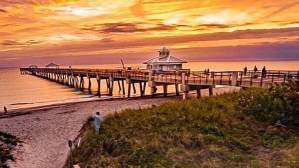 A wooden staircase leading to a beach with a wooden pier extending into the water. - PARADIZE FOR EQUESTRIAN LOVERS (Wellington)