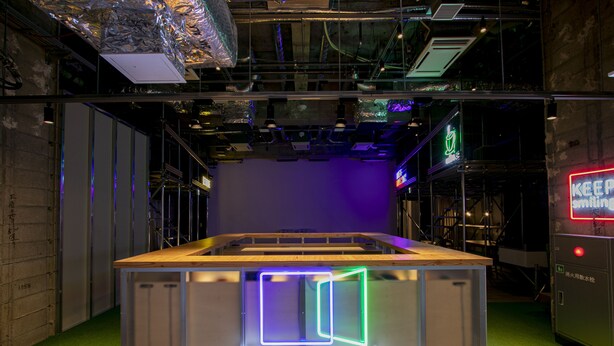 A theater with a neon sign, green carpet, and industrial-style ceiling. - Theatel Sapporo (Sapporo)