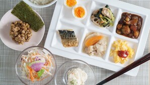 A variety of Japanese dishes including rice, fish, and vegetables, served on multiple plates. - Super Hotel Midousuji Line Esaka (Suita)