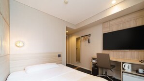 A hotel room with a bed, a desk, a chair, a television, and a coffee machine. - Super Hotel Midousuji Line Esaka (Suita)