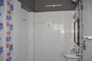 Bathroom features a sink, mirror, and towel rack.