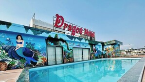 A hotel with a pool and a mural of a mermaid. - Dragon Hotel (Bai Chay)