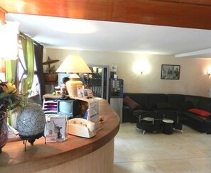 Relax in the reception area with a comfortable sofa, a telephone, and a television.
